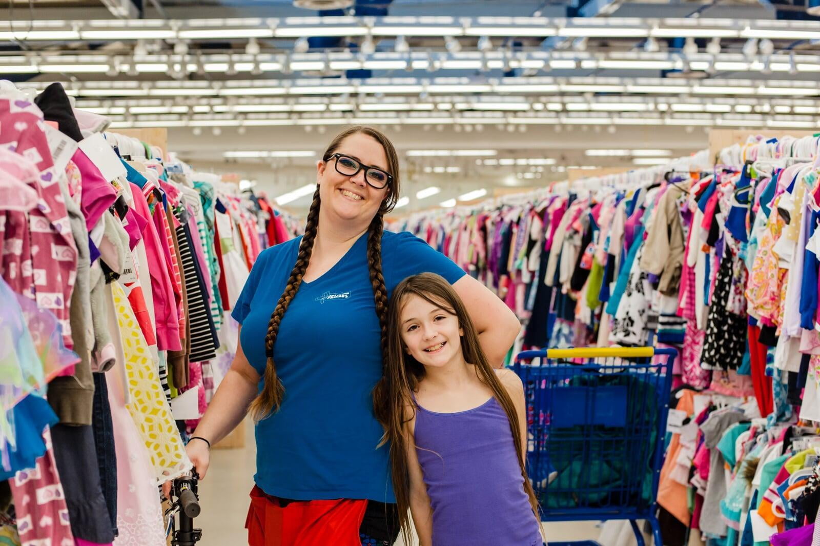 Mom and daughter shopping for their families at the local JBF sale.